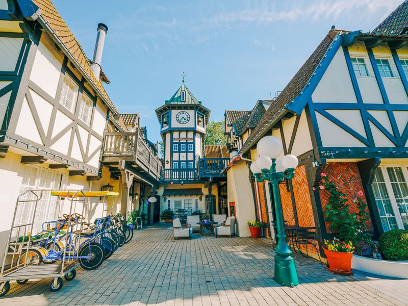 A brick-lined street in Solvang with traditional Danish timber architecture.